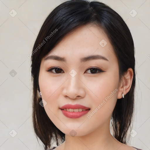 Joyful asian young-adult female with medium  black hair and brown eyes