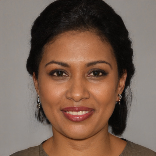 Joyful black young-adult female with medium  black hair and brown eyes