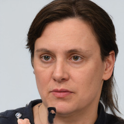 Joyful white adult female with medium  brown hair and grey eyes