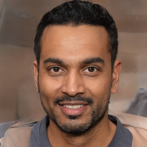 Joyful latino young-adult male with short  black hair and brown eyes