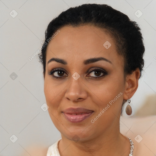 Joyful black young-adult female with short  brown hair and brown eyes