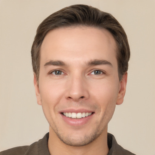 Joyful white young-adult male with short  brown hair and brown eyes