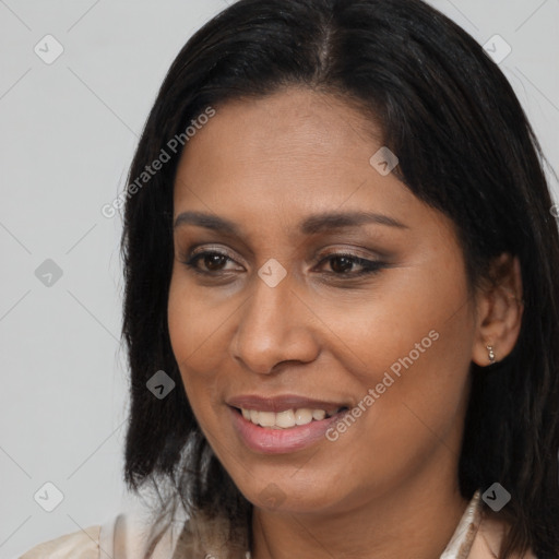 Joyful latino young-adult female with long  brown hair and brown eyes