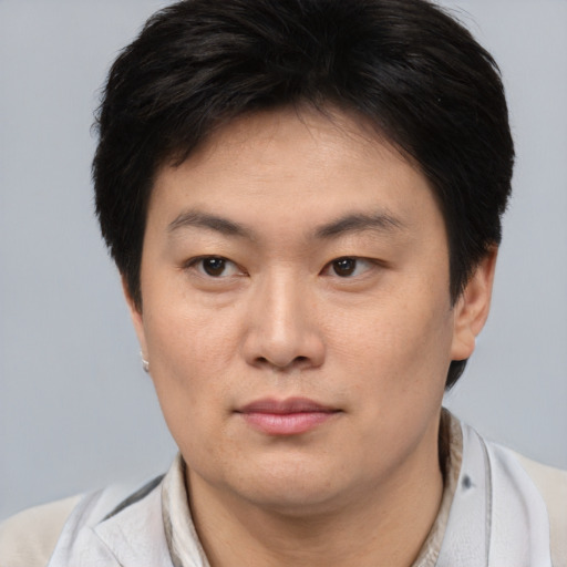 Neutral asian young-adult male with short  brown hair and brown eyes