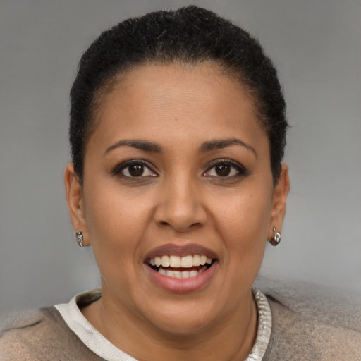Joyful black young-adult female with short  brown hair and brown eyes
