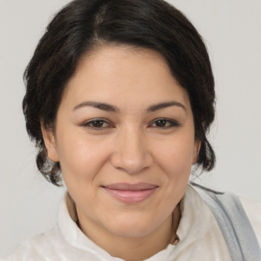 Joyful latino adult female with medium  brown hair and brown eyes