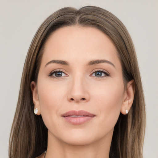 Joyful white young-adult female with long  brown hair and grey eyes