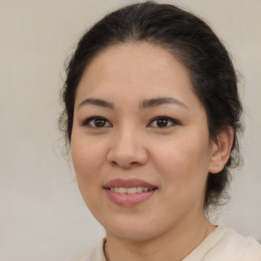 Joyful latino young-adult female with medium  brown hair and brown eyes