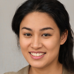 Joyful latino young-adult female with long  brown hair and brown eyes