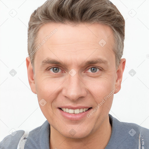 Joyful white adult male with short  brown hair and grey eyes