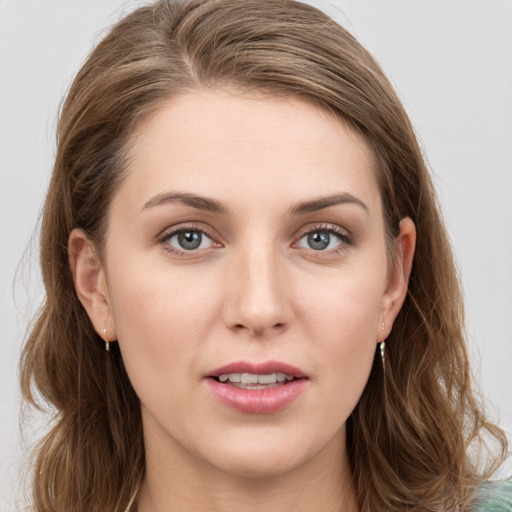 Joyful white young-adult female with long  brown hair and grey eyes