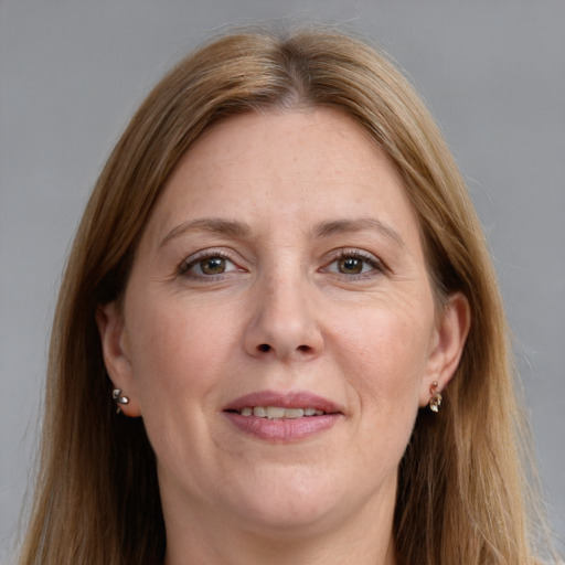 Joyful white adult female with long  brown hair and grey eyes