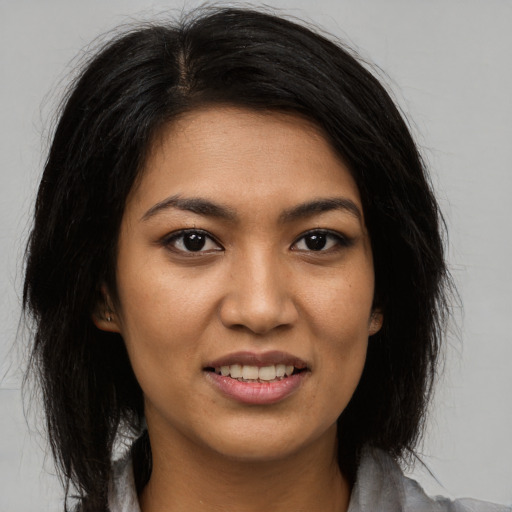 Joyful asian young-adult female with long  black hair and brown eyes