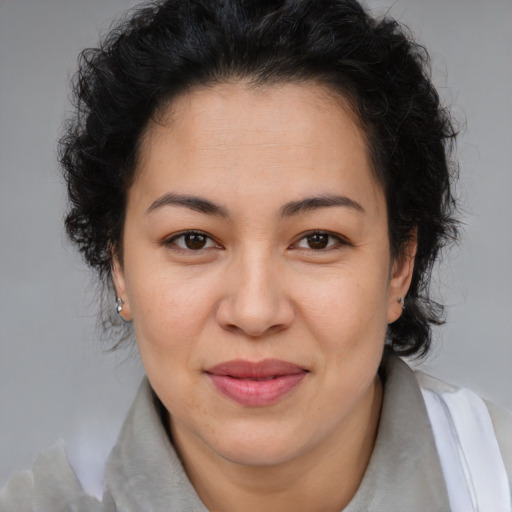 Joyful asian adult female with medium  brown hair and brown eyes