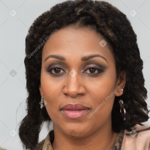 Joyful black young-adult female with long  brown hair and brown eyes