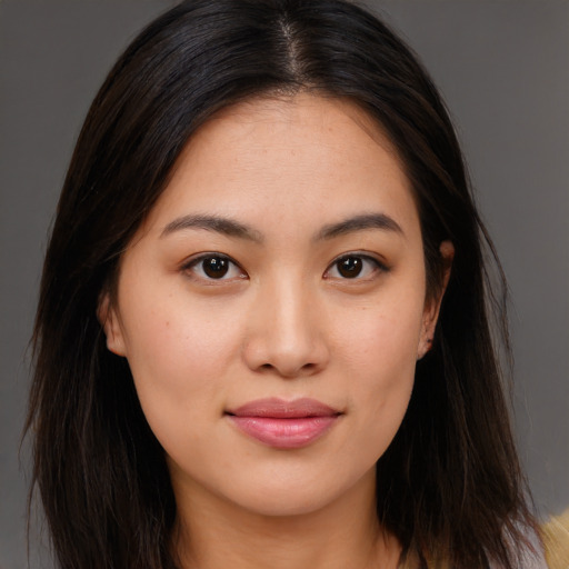 Joyful asian young-adult female with long  brown hair and brown eyes