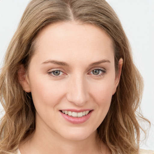 Joyful white young-adult female with long  brown hair and green eyes