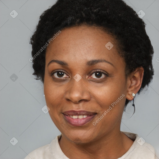 Joyful black adult female with short  brown hair and brown eyes