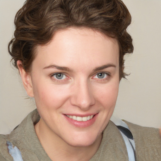 Joyful white young-adult female with medium  brown hair and blue eyes