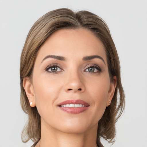 Joyful white young-adult female with medium  brown hair and grey eyes