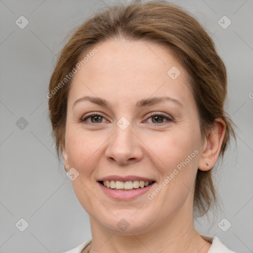 Joyful white adult female with medium  brown hair and green eyes