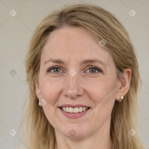 Joyful white adult female with long  brown hair and grey eyes