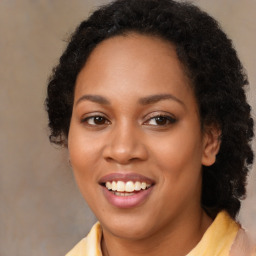 Joyful black young-adult female with long  brown hair and brown eyes