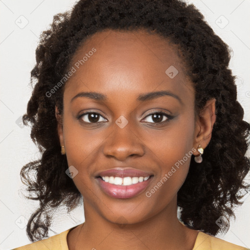 Joyful black young-adult female with long  brown hair and brown eyes