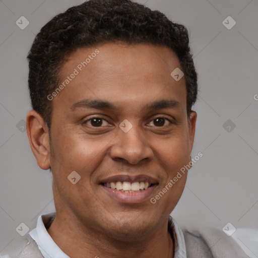 Joyful latino young-adult male with short  brown hair and brown eyes