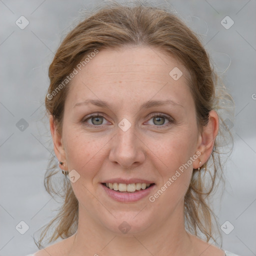 Joyful white adult female with medium  brown hair and grey eyes