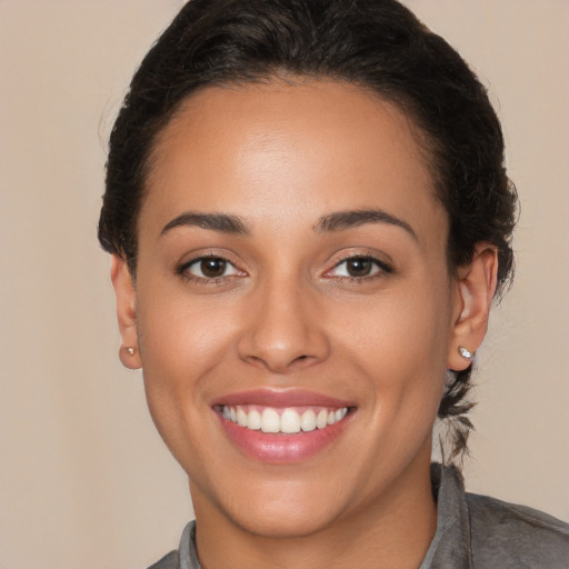 Joyful white young-adult female with short  brown hair and brown eyes