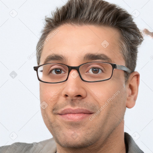 Joyful white adult male with short  brown hair and brown eyes