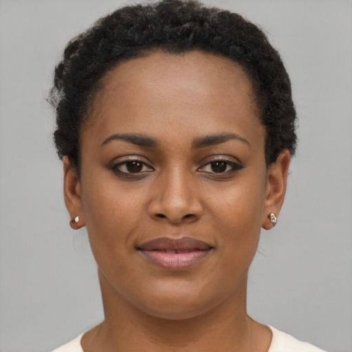 Joyful black young-adult female with short  brown hair and brown eyes