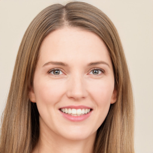 Joyful white young-adult female with long  brown hair and green eyes