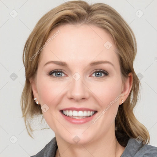 Joyful white young-adult female with medium  brown hair and blue eyes