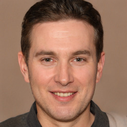 Joyful white adult male with short  brown hair and brown eyes