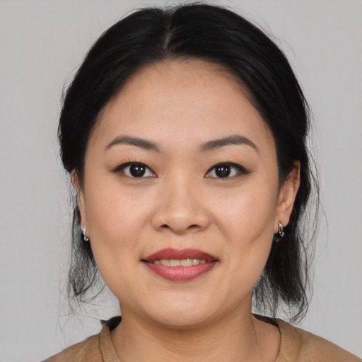 Joyful asian young-adult female with medium  brown hair and brown eyes