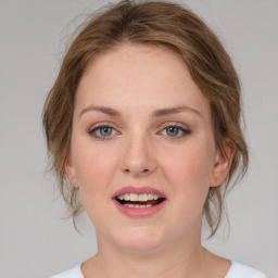 Joyful white young-adult female with medium  brown hair and blue eyes