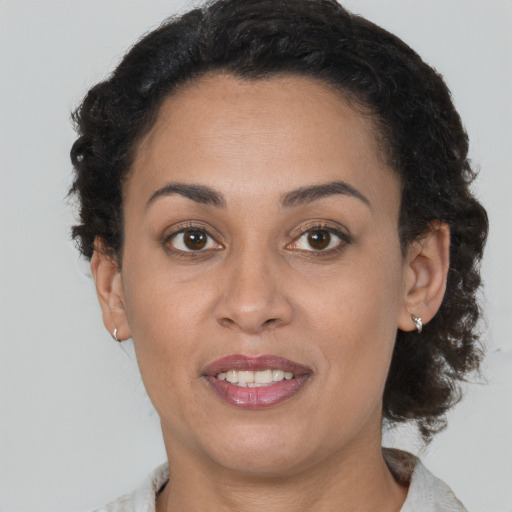 Joyful latino young-adult female with short  brown hair and brown eyes