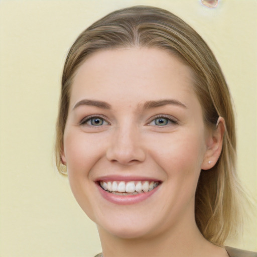 Joyful white young-adult female with long  brown hair and green eyes