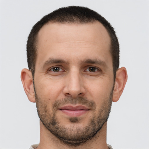 Joyful white young-adult male with short  brown hair and brown eyes