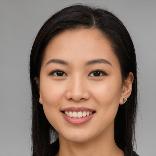 Joyful asian young-adult female with long  brown hair and brown eyes