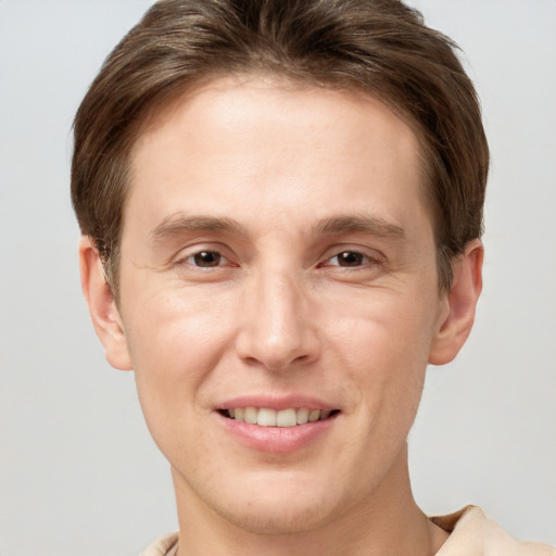 Joyful white adult male with short  brown hair and grey eyes