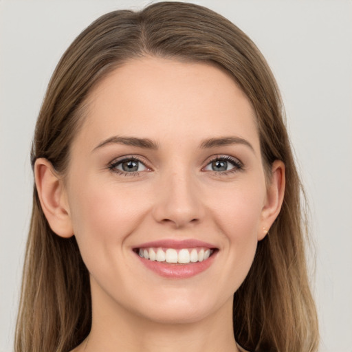 Joyful white young-adult female with long  brown hair and grey eyes