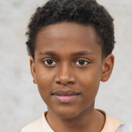 Joyful black child male with short  brown hair and brown eyes