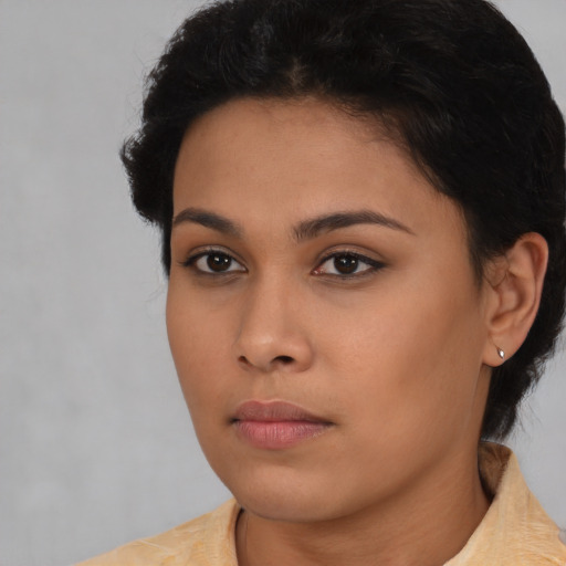Neutral latino young-adult female with short  black hair and brown eyes