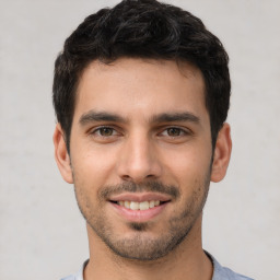 Joyful white young-adult male with short  black hair and brown eyes