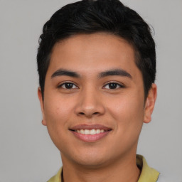 Joyful asian young-adult male with short  brown hair and brown eyes