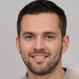 Joyful white young-adult male with short  brown hair and brown eyes