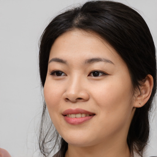 Joyful asian young-adult female with medium  black hair and brown eyes